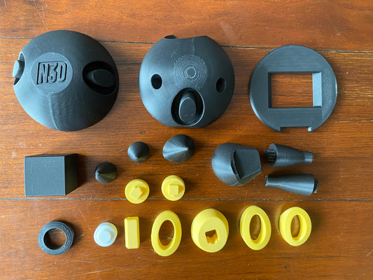 Collection of parts for the Umbreon Monster Ball on a wooden surface