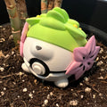 Shaymin Character Ball collectible side view showing the flower and grass-tuft detail