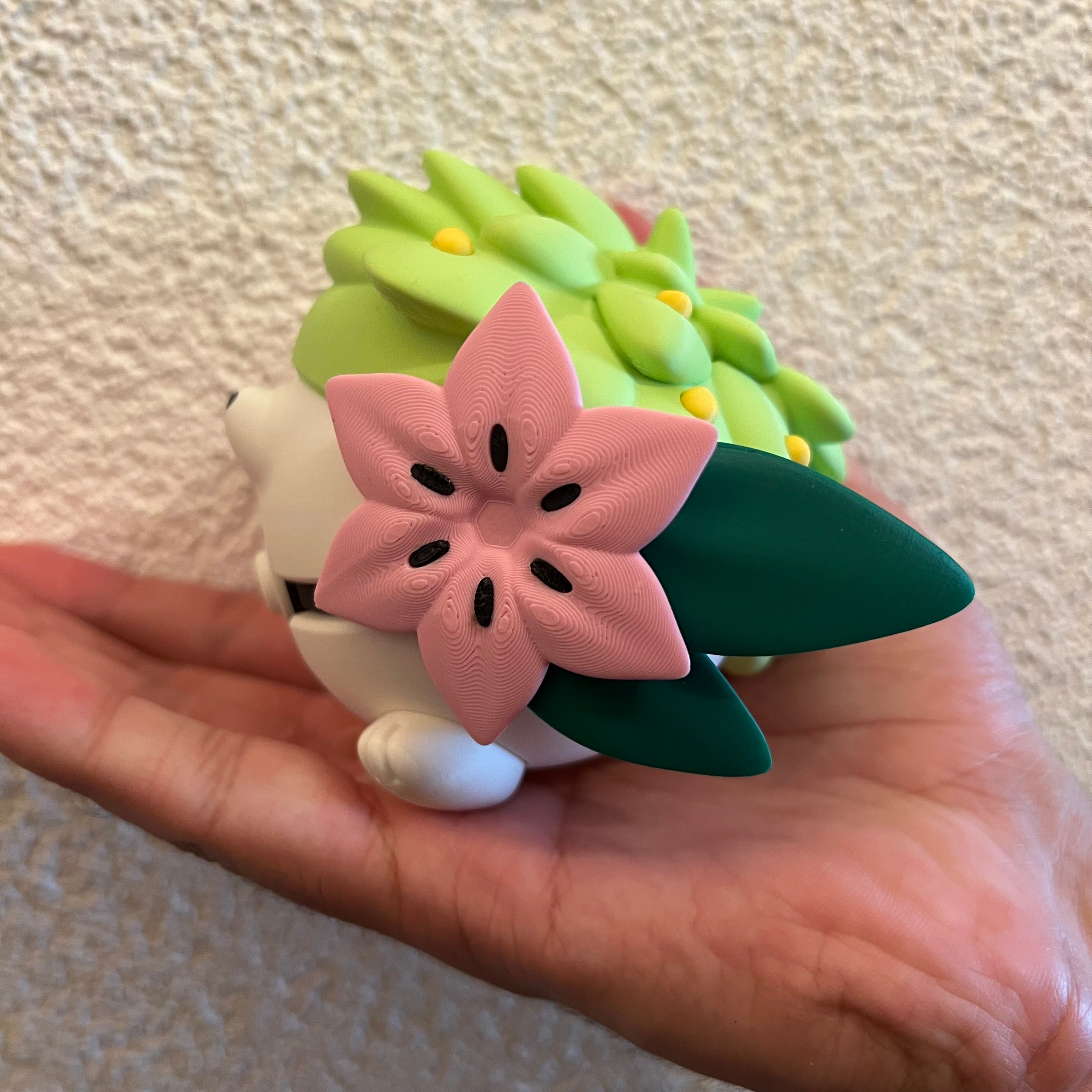 Shaymin Character Ball collectible held in hand for scale