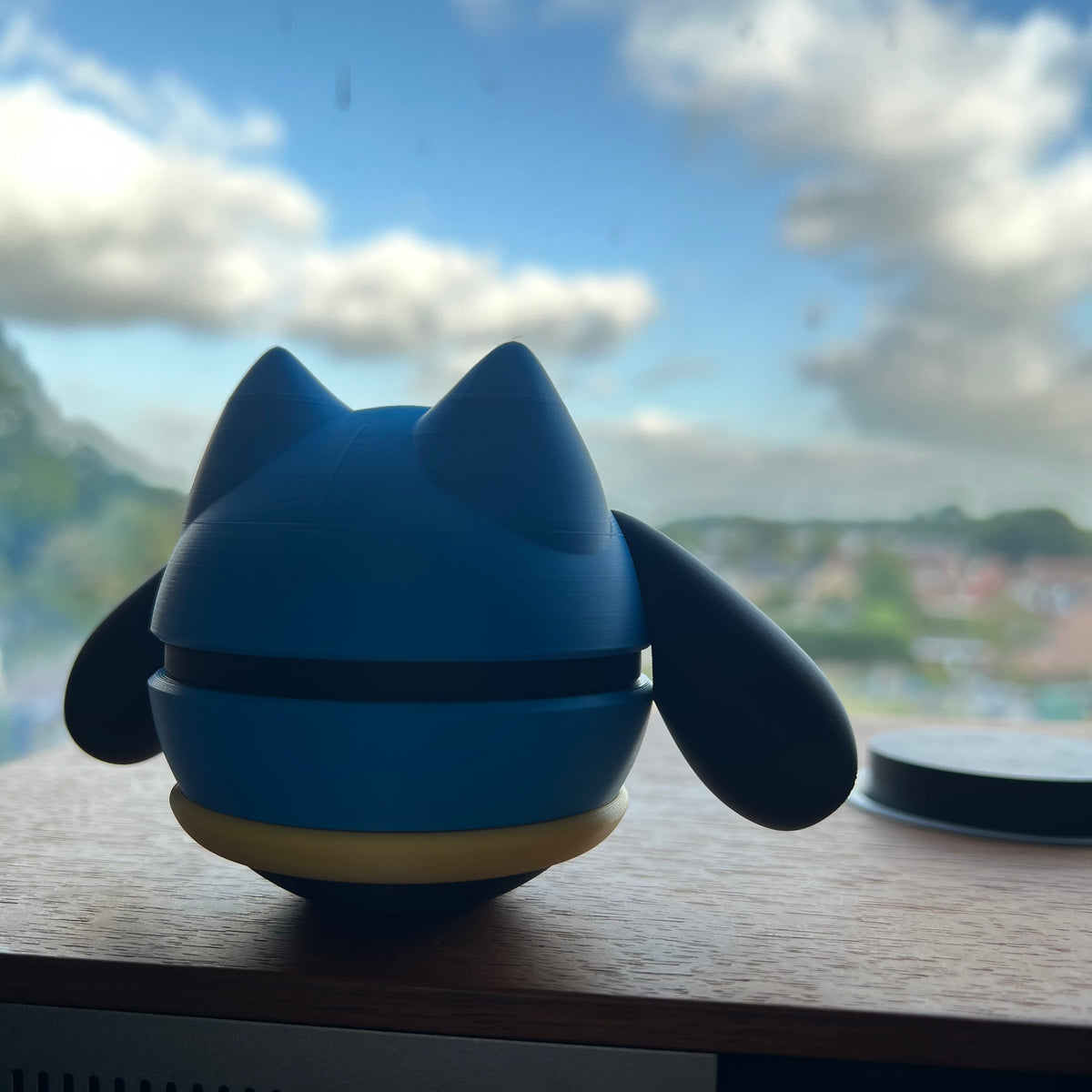 Riolu 3D printed Character Ball on a windowsill, backlit by daylight