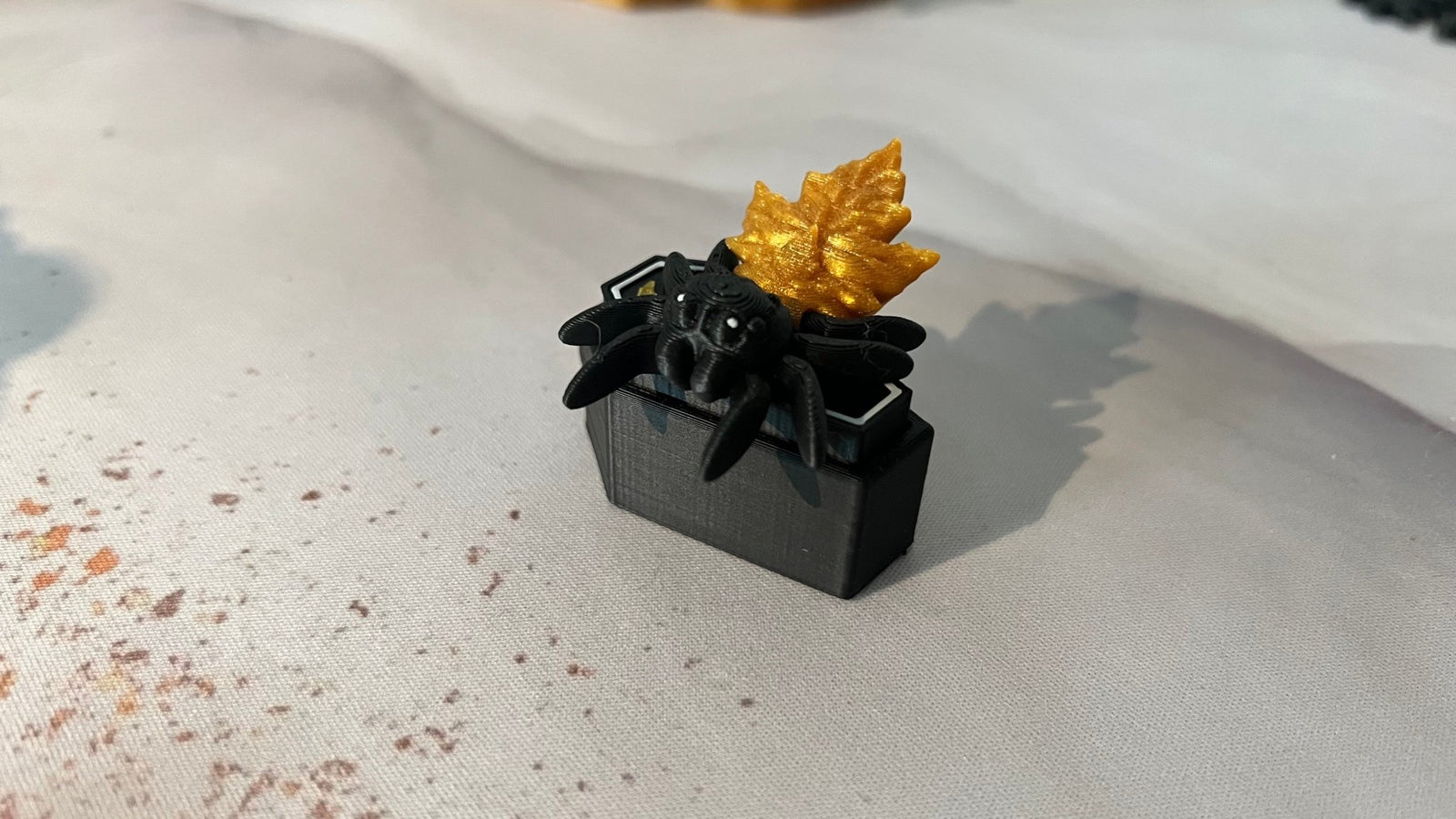 Jeremy the Jumping Spider articulated 3D printed fidget toy with his miniature autumn leaf