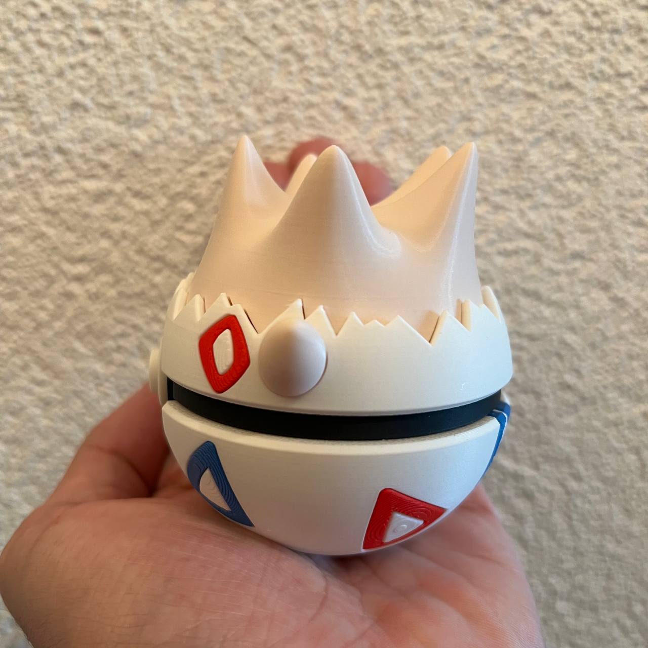 Togepi Character Ball collectible side view showing the shell pattern detail